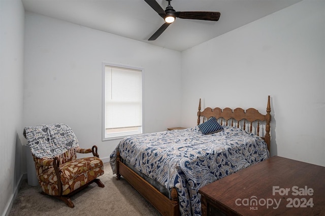 bedroom with ceiling fan and light carpet