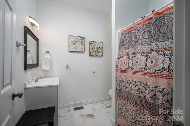 bathroom with vanity, a shower with shower curtain, and toilet