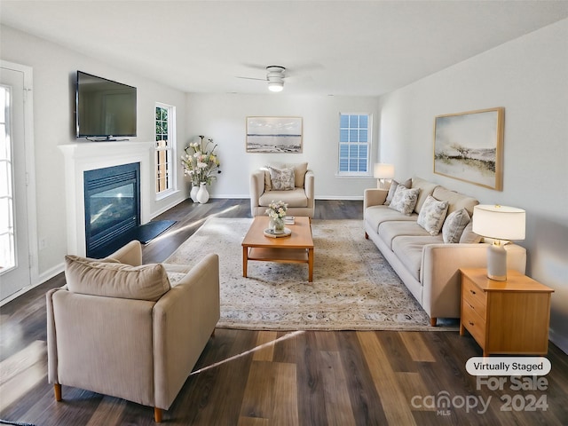 living room featuring ceiling fan and dark hardwood / wood-style flooring