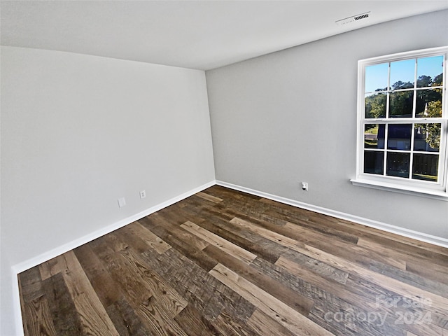 unfurnished room featuring dark wood-type flooring