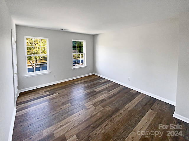 unfurnished room featuring dark hardwood / wood-style floors