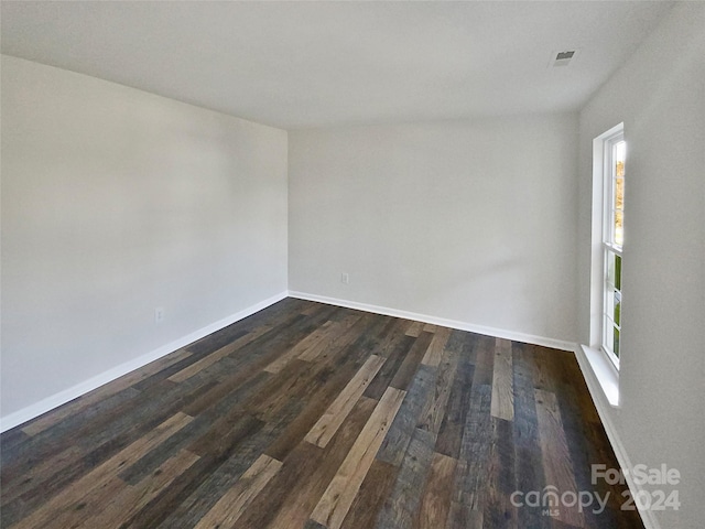 empty room with dark wood-type flooring