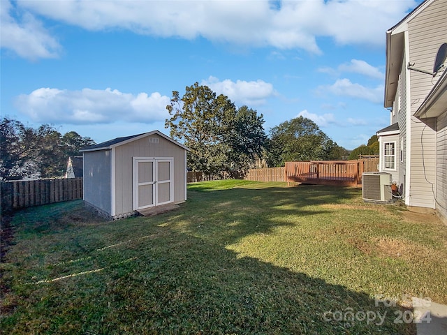 view of yard featuring central AC and a shed