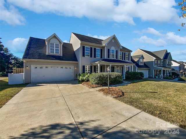 view of front of house featuring a front lawn and a garage