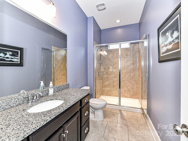 bathroom with tile patterned flooring, vanity, toilet, and walk in shower