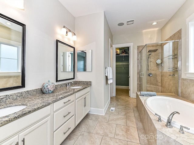 bathroom with shower with separate bathtub, vanity, and tile patterned floors