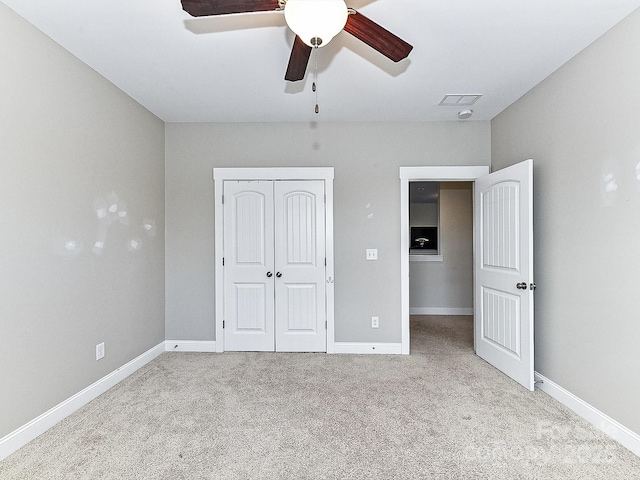 unfurnished bedroom featuring ceiling fan, light carpet, and a closet