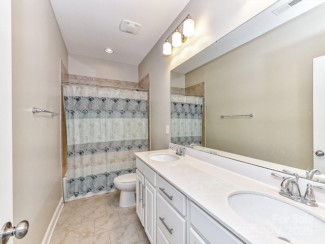 full bathroom with tile patterned flooring, vanity, toilet, and shower / bath combo with shower curtain