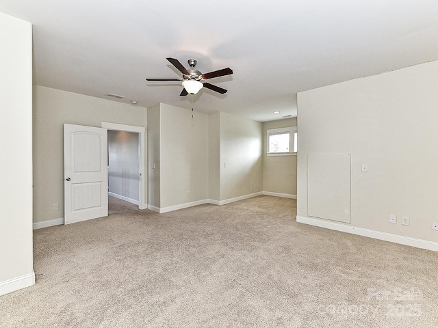 spare room featuring ceiling fan and light colored carpet