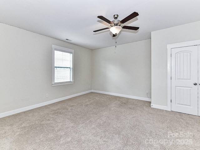 unfurnished room featuring ceiling fan and light carpet