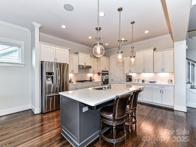 kitchen with pendant lighting, sink, an island with sink, white cabinetry, and stainless steel appliances