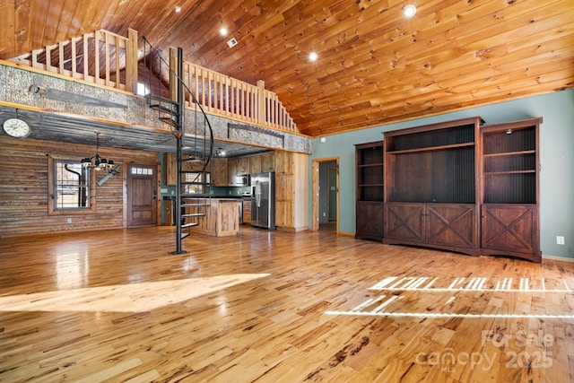 unfurnished living room featuring high vaulted ceiling and light hardwood / wood-style flooring