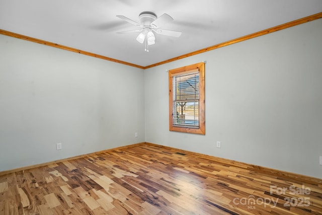 empty room with hardwood / wood-style flooring, ceiling fan, and ornamental molding