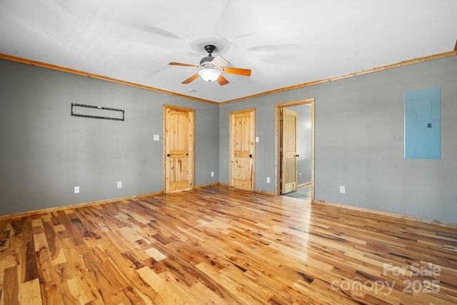 interior space with electric panel, crown molding, ceiling fan, and light hardwood / wood-style flooring