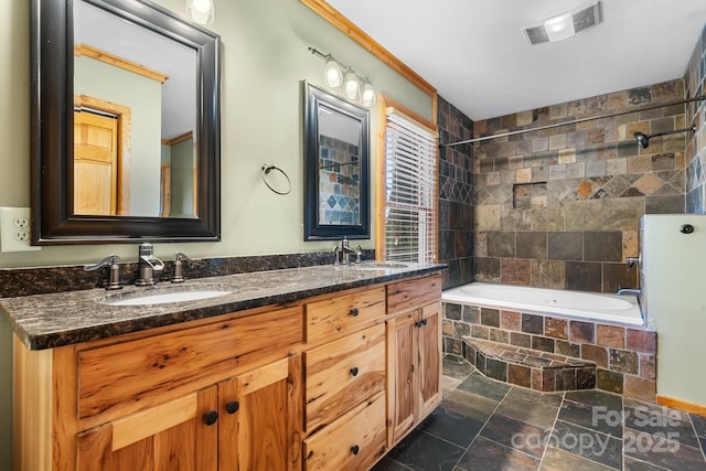 bathroom featuring tiled shower / bath combo and vanity