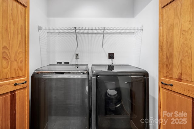 laundry area with washing machine and clothes dryer