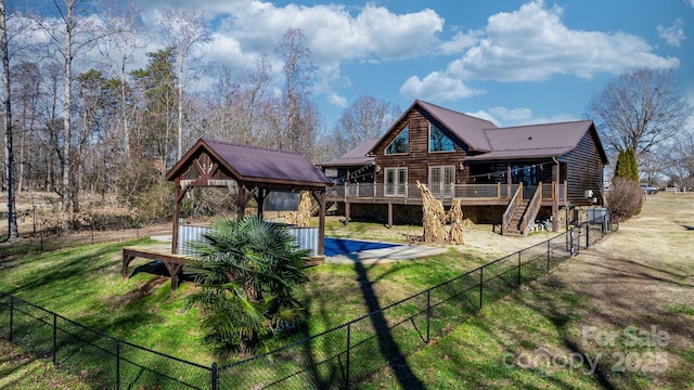 back of house featuring a yard and a deck