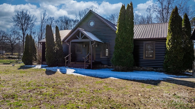 log cabin with a front lawn