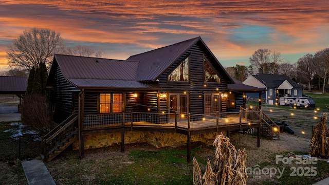 view of back house at dusk