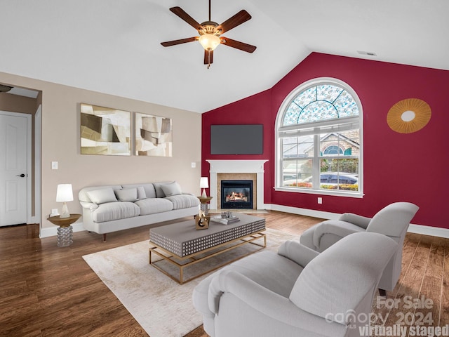 living room featuring hardwood / wood-style flooring, ceiling fan, and vaulted ceiling