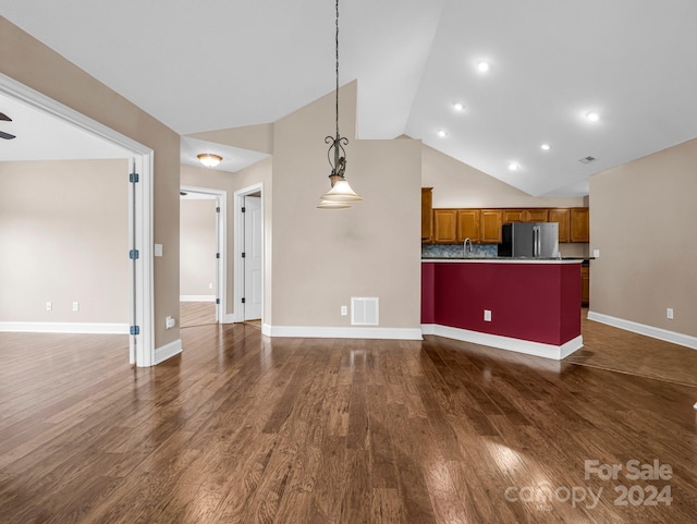 unfurnished living room with dark wood-type flooring, vaulted ceiling, and ceiling fan