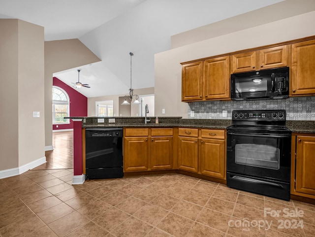 kitchen with ceiling fan with notable chandelier, black appliances, tasteful backsplash, high vaulted ceiling, and dark stone countertops