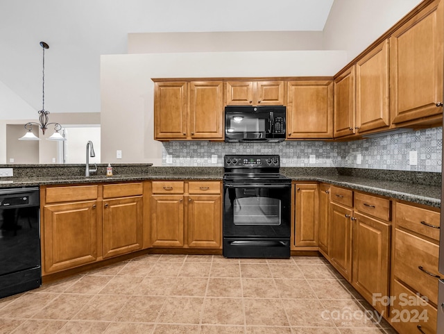 kitchen featuring dark stone countertops, black appliances, and decorative backsplash