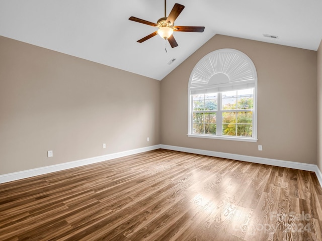 spare room with light wood-type flooring, ceiling fan, and vaulted ceiling