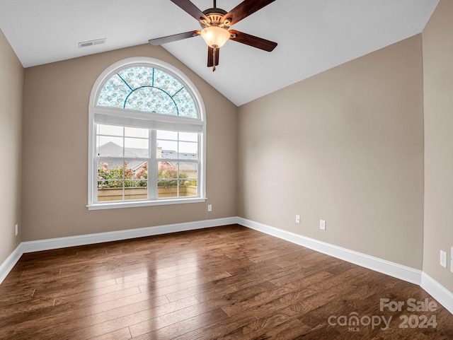 unfurnished room with dark hardwood / wood-style floors, ceiling fan, and vaulted ceiling