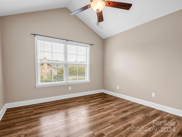 unfurnished room with dark hardwood / wood-style flooring, lofted ceiling, and ceiling fan