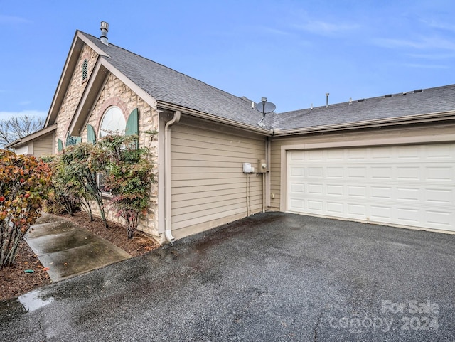 view of side of home with a garage