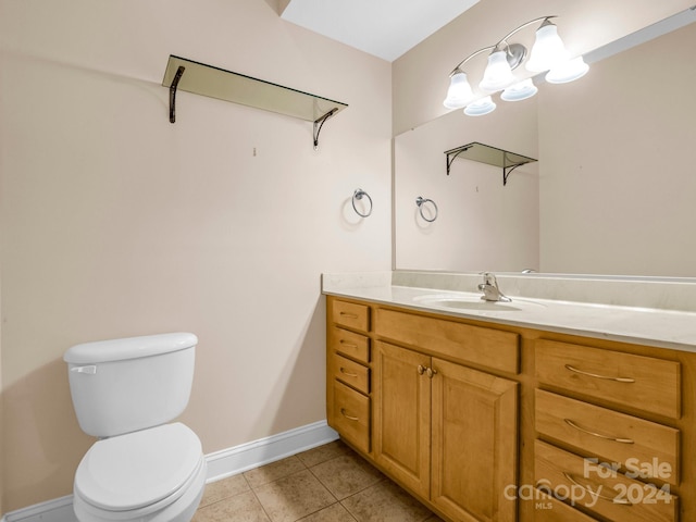 bathroom featuring toilet, vanity, and tile patterned floors