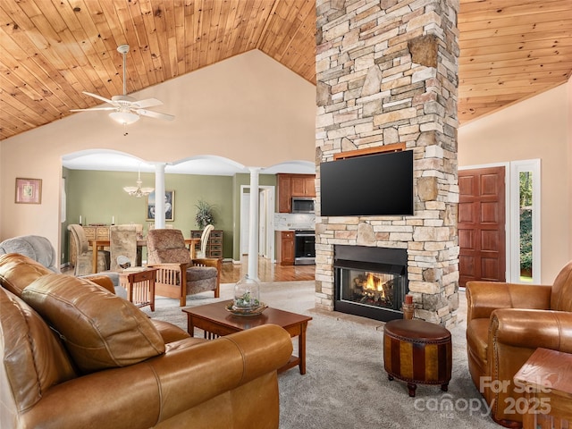 carpeted living room with decorative columns, high vaulted ceiling, wooden ceiling, and a fireplace