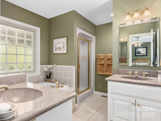 bathroom with tile patterned floors, plus walk in shower, vanity, and ceiling fan