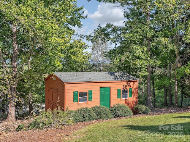 view of front of house featuring a front yard and an outdoor structure