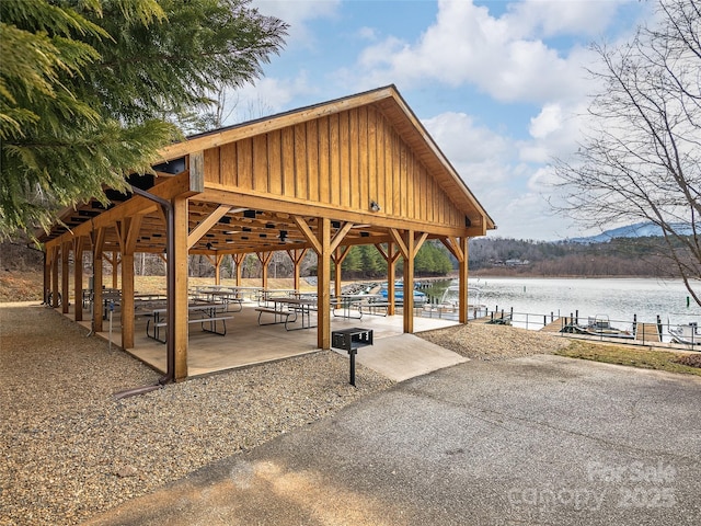 view of property's community with a patio, a water view, and a gazebo