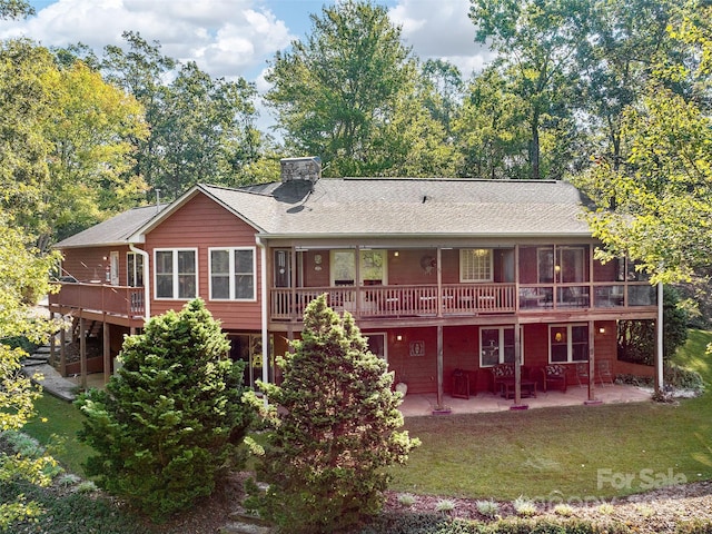 121 Canoe Dr, Mill Spring, NC 28756 - back of house with a wooden deck, a lawn, roof with shingles, a patio area, and a chimney