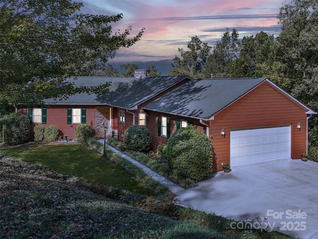 121 Canoe Dr, Mill Spring, NC 28756 - ranch-style house with concrete driveway, a chimney, a front lawn, an attached garage, and a shingled roof