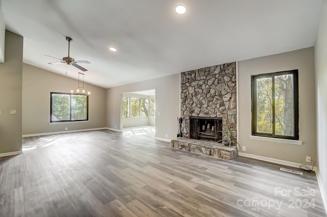 unfurnished living room with plenty of natural light, light hardwood / wood-style flooring, and vaulted ceiling