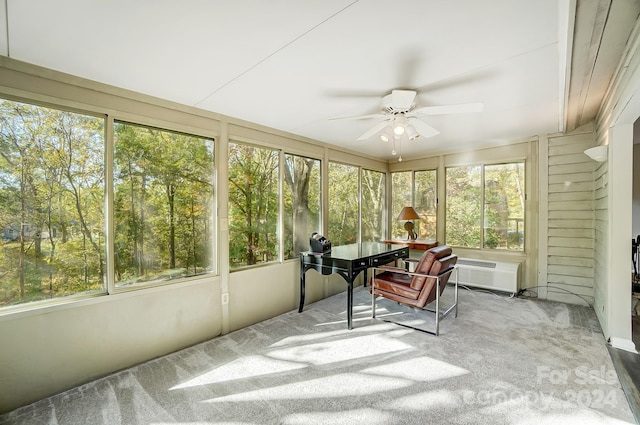 sunroom / solarium with a wealth of natural light, a wall unit AC, and ceiling fan