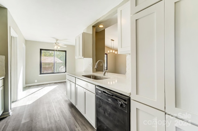 kitchen featuring white cabinetry, black dishwasher, sink, hardwood / wood-style flooring, and ceiling fan