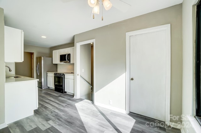 kitchen featuring white cabinetry, light hardwood / wood-style floors, stainless steel appliances, and sink