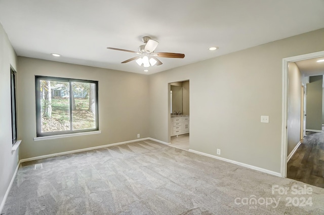 carpeted empty room featuring ceiling fan