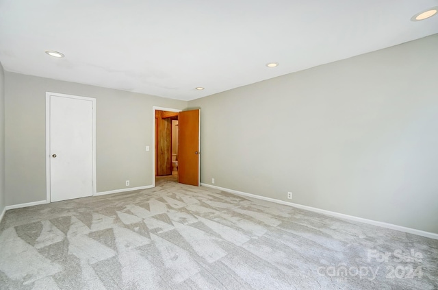 unfurnished room featuring light colored carpet