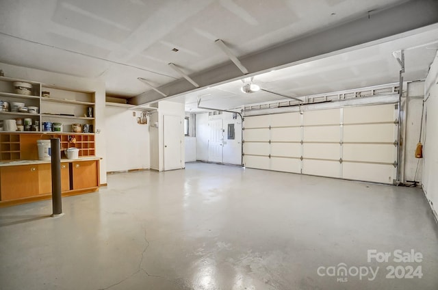 garage featuring electric panel and a garage door opener