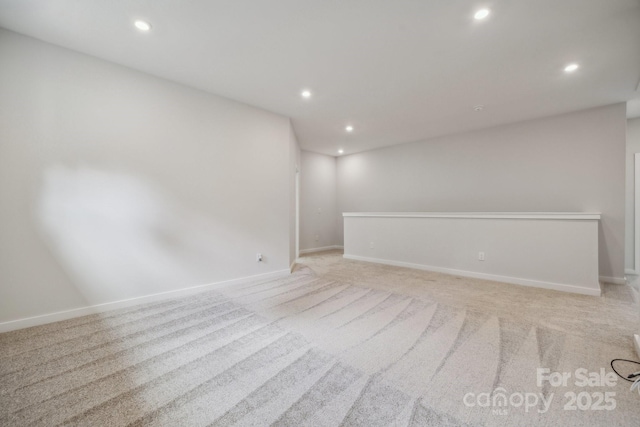 unfurnished room featuring light colored carpet