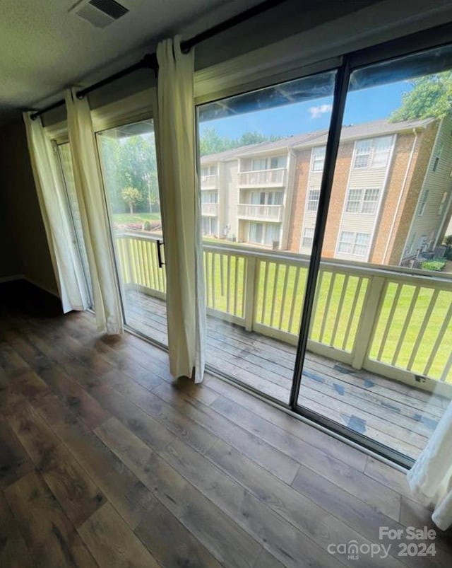 doorway to outside with wood-type flooring