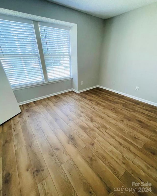 spare room with hardwood / wood-style flooring