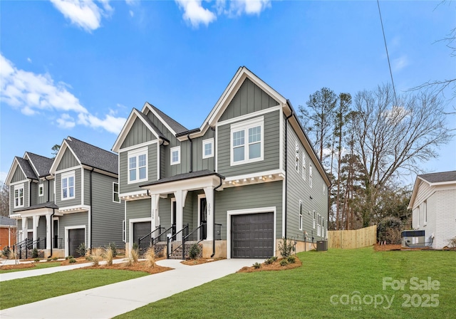 craftsman house with a garage and a front lawn