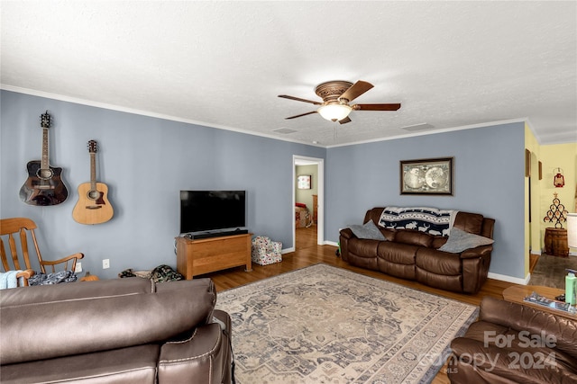 living room featuring ornamental molding, a textured ceiling, dark wood-type flooring, and ceiling fan